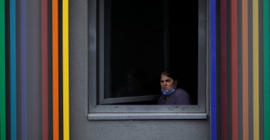 A woman looks out from a dormitory where she is placed under quarantine after returning from abroad, in Istanbul, Turkey, March 18, 2020. (REUTERS Photo)