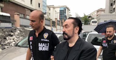 Adnan Oktar is escorted by police after his arrest, in Istanbul, Turkey, July 11, 2018. (DHA PHOTO)