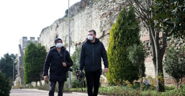Barış Sözal of Sabah newspaper (L) and Caner Sönmez of IHA, walk near the ancient city walls, in Istanbul, Turkey, Jan. 10, 2021. (AA Photo)
