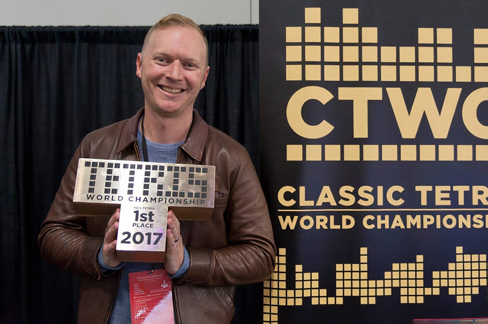 Jonas Neubauer poses with his trophy at the 8th annual Classic Tetris World Championship at the Portland Retro Gaming Expo at the Oregon Convention Center on Oct. 22, 2017. (Image Credit: Classic Tetris World Championship)