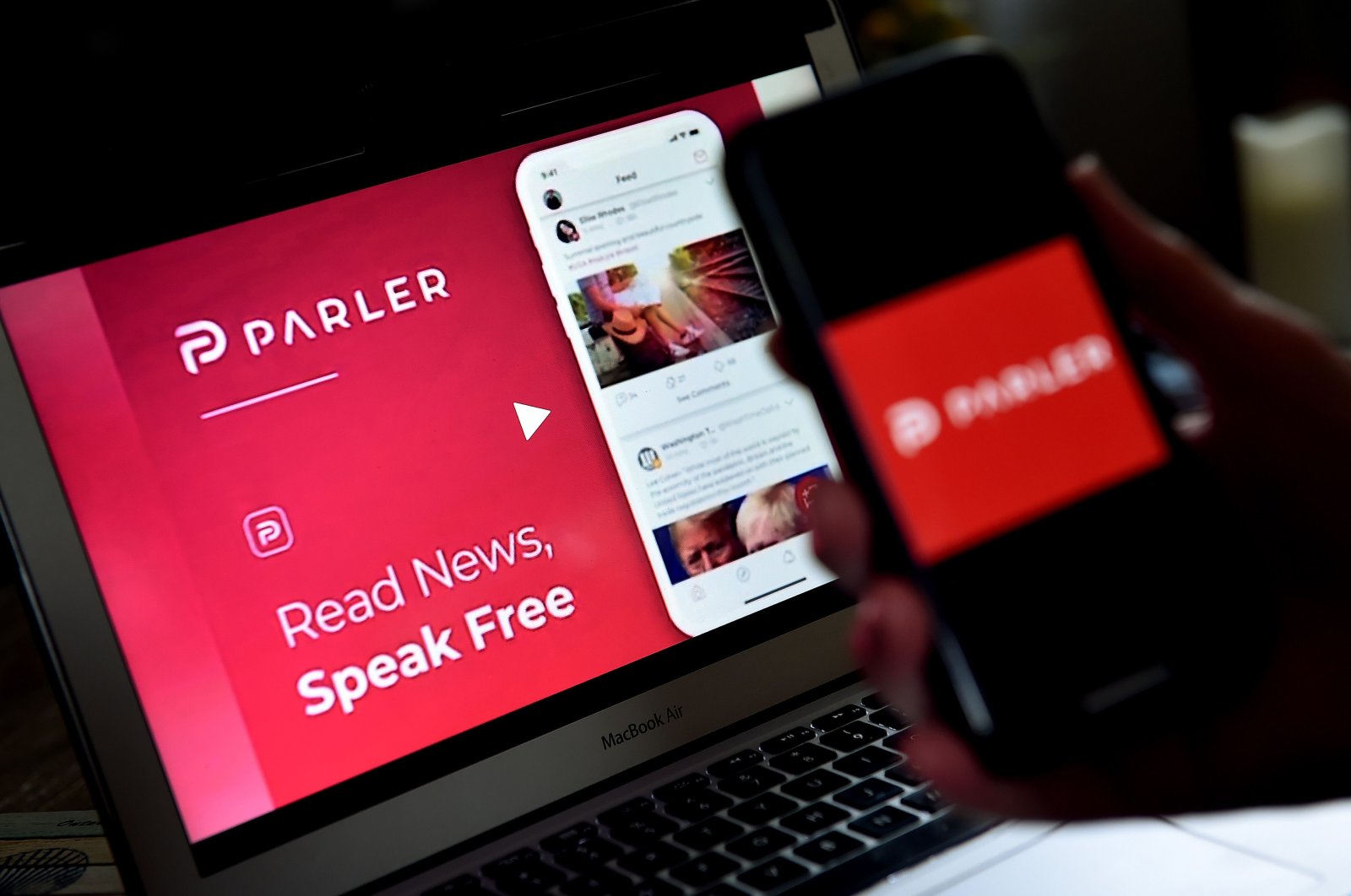An illustration picture shows a social media application logo from Parler displayed on a smartphone with its website in the background in Arlington, Virginia, the U.S., July 1, 2020. (AFP Photo)