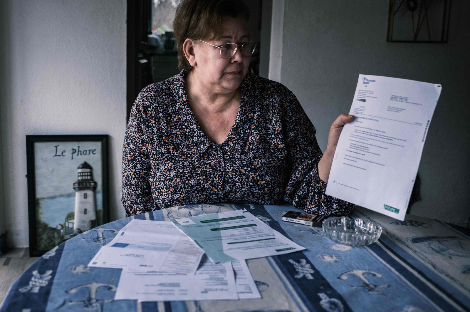 Jeanne Pouchain who, since November 2017, has been declared dead by the justice system after being convicted by the Prud'hommes, shows some paperwork, in Saint-Joseph, France, Jan. 8, 2021. (AFP Photo)