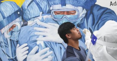 Medical personnel collects a swab sample from a man during a COVID-19 test at Ajwa clinic in Shah Alam, outside Kuala Lumpur, Malaysia, Jan. 11, 2021. (EPA-EFE Photo)