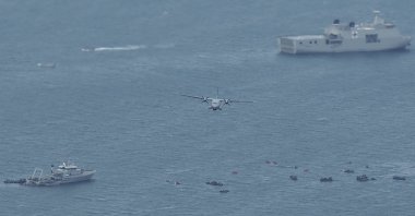 Indonesian Navy's aircraft flies by as the search for the wreckage of a crashed Sriwijaya Air passenger jet continues, in this aerial photo taken over the Java Sea, off Jakarta, Indonesia, Jan. 12, 2021. (AP Photo)