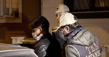 Police escort a FETÖ suspect captured in Istanbul, Turkey, Jan. 12, 2021. (AA PHOTO) 