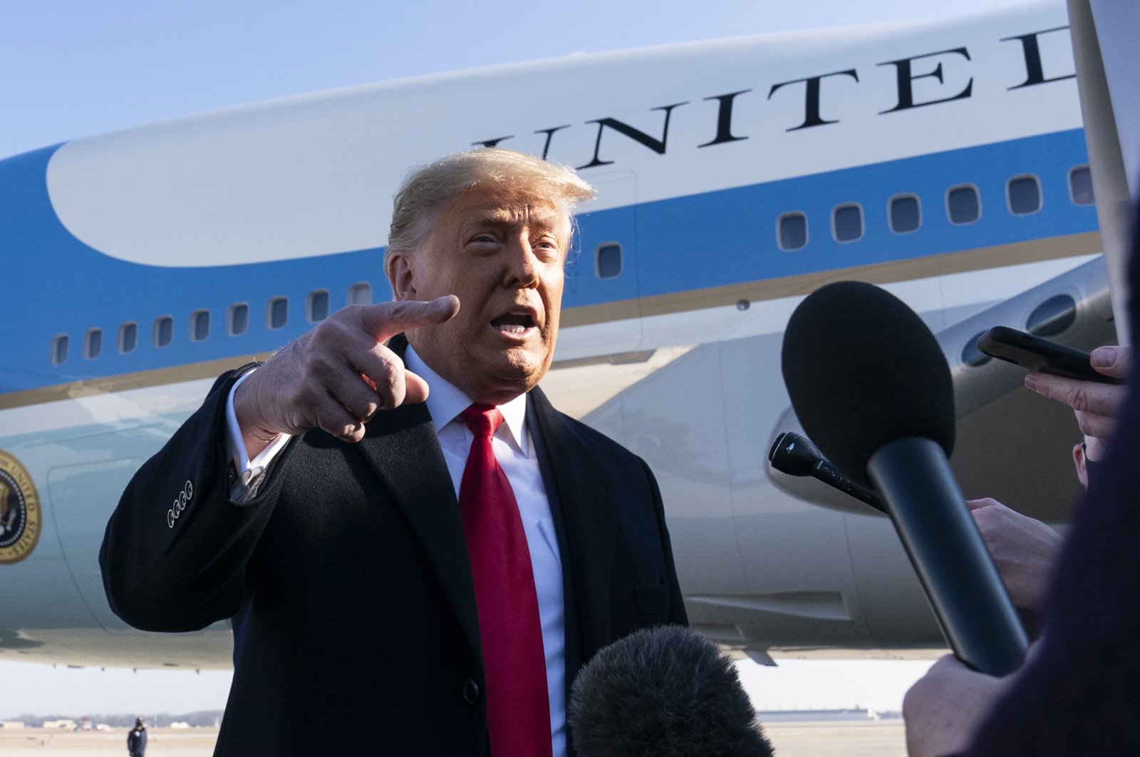 U.S. President Donald Trump speaks with reporters before boarding Air Force One upon departure, at Andrews Air Force Base, Maryland on Jan. 12, 2021. (AP Photo)
