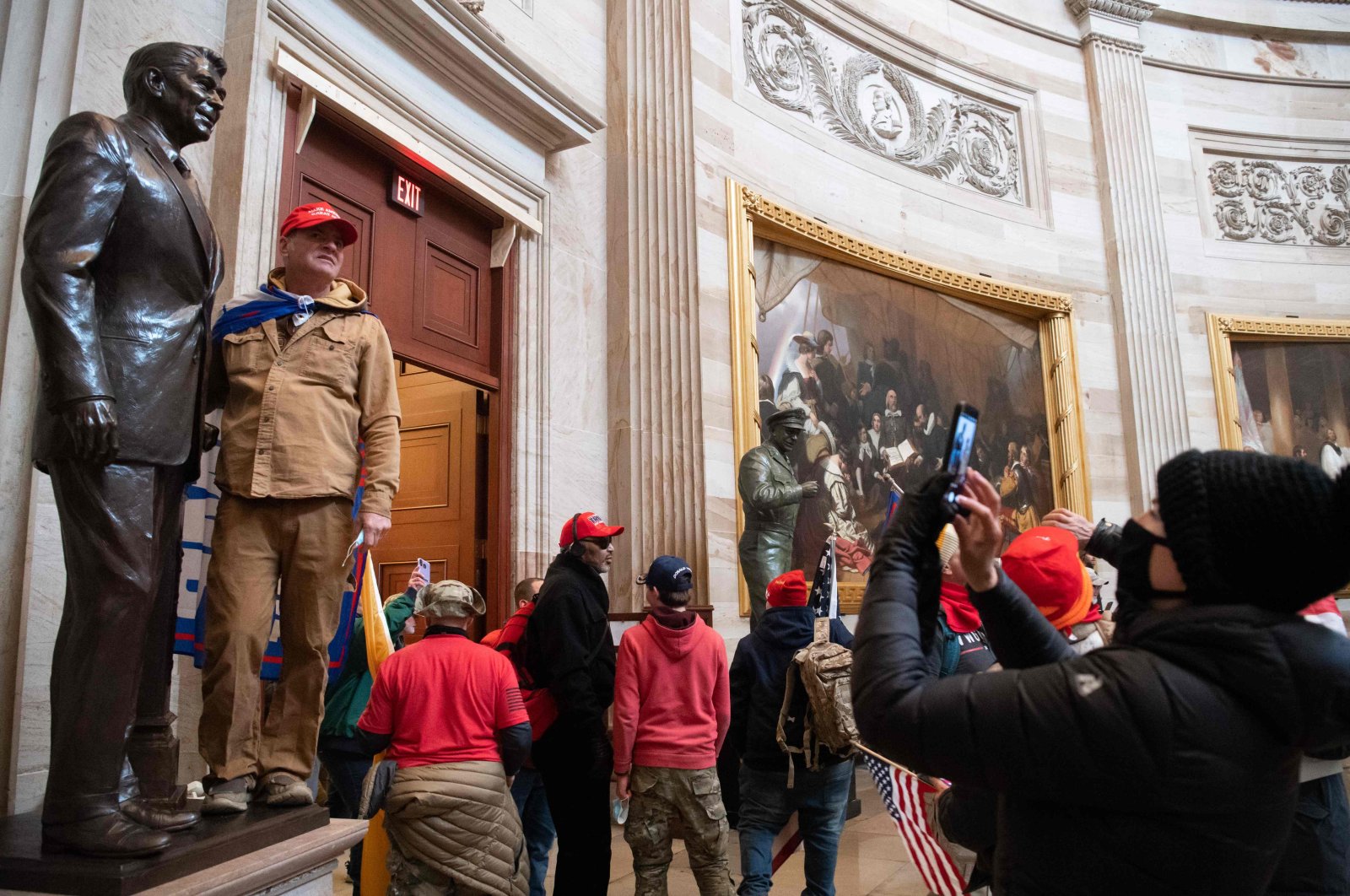 Supporters of U.S. President Donald Trump pose with statues inside the Rotunda after breaching the U.S. Capitol in Washington, D.C., Jan. 6, 2021. (AFP Photo)