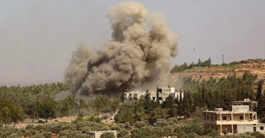 In this file photo, smoke billows following a reported airstrike on the western outskirts of the Syrian province of Idlib, Sept. 20, 2020. (AFP Photo)