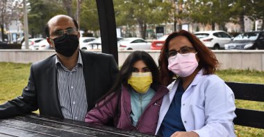 Ibrahim Halil Yıldırım (L) and Seval Cing Yıldırım (R) pose with their daughter Ayşe Damla, in Konya, central Turkey, Jan. 13, 2021. (AA Photo)