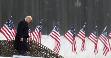 President Donald Trump walks down the steps before a speech near a section of the U.S.-Mexico border wall, Alamo, Texas on Jan. 12, 2021. (AP Photo)