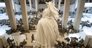 Hundreds of US National Guard troops rest in the Capitol Visitors Center, with the Statue of Freedom seen at center, on Capitol Hill in Washington, DC, USA, 13 January 2021. (EPA Photo)