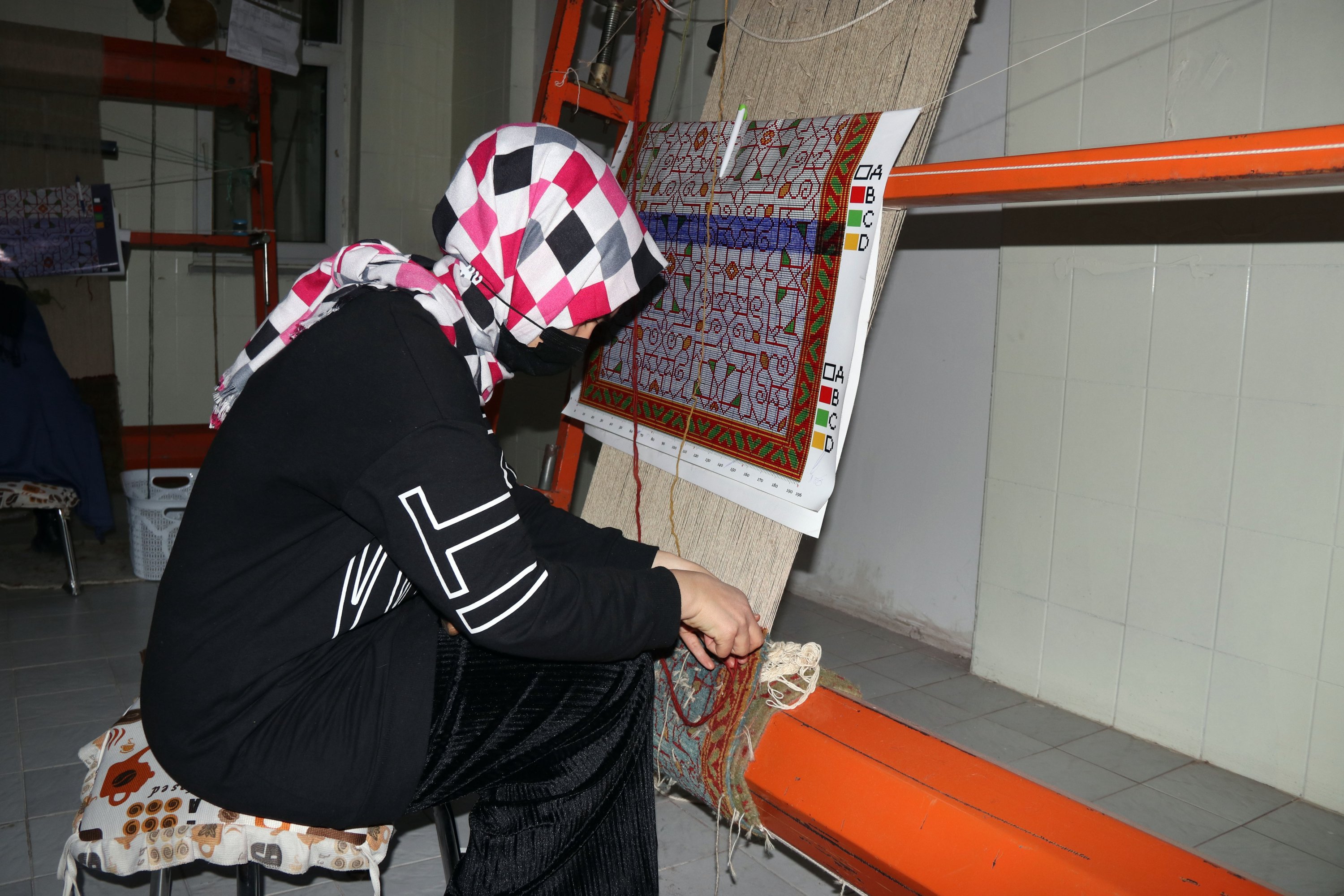 A local woman weaves a carpet at the workshop in Iğdır, eastern Turkey, Jan. 13, 2021. (AA Photo)