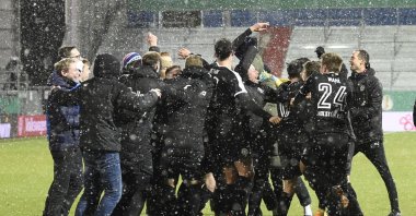 Kiel's players celebrate after beating Bayern Munich during the DFB Cup 2nd round match between Holstein Kiel and Bayern Munich at the Holstein Stadium in Kiel, Germany, Wednesday Jan. 13, 2021. (Reuters Photo)