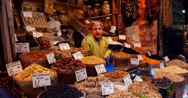 A Turkish stallholder selling dried fruits and nuts at the Spice Bazaar in Istanbul, May 20, 2010. (Getty Images Photo)