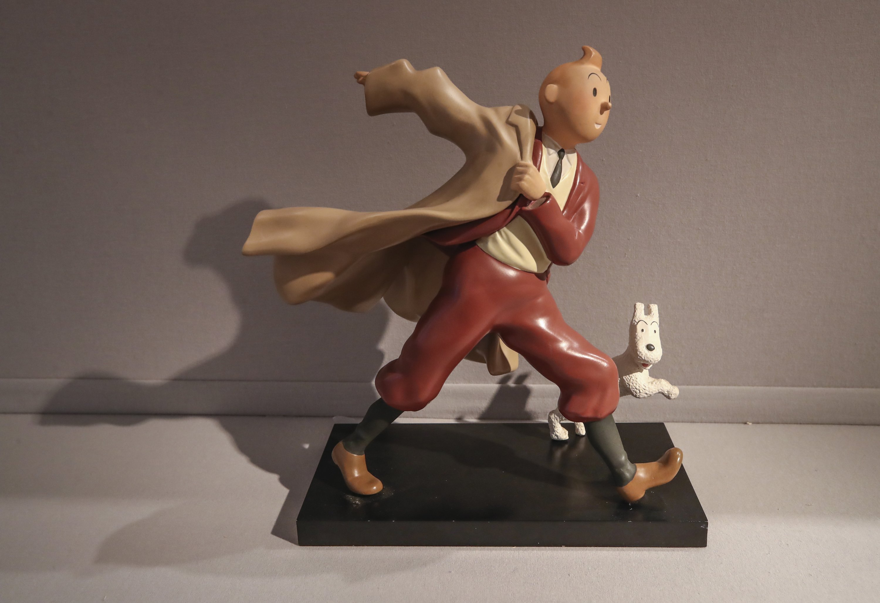 A 1988 polychrome resin sculpture of the comic character Tintin and his dog snowy from the 1941 "The Crab with the Golden Claws" album drawn by Belgian creator Herge is displayed at the Artcurial auction house in Paris on Jan. 13, 2021. (AP Photo)