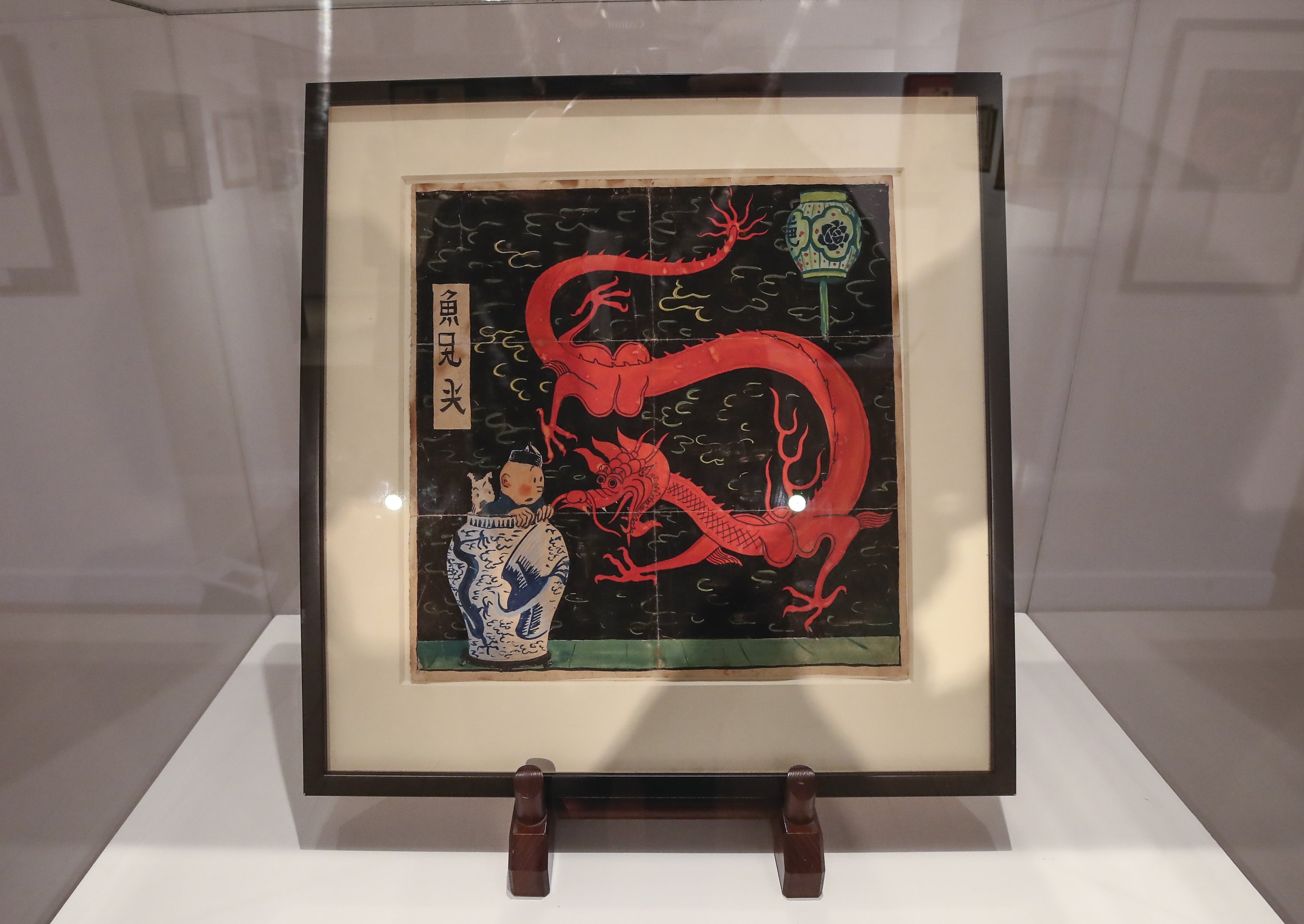 The inked and water-painted original panel of the comic character Tintin from the 1936 "The Blue Lotus" album drawn by Belgian creator Herge, is displayed at the Artcurial auction house in Paris on Jan. 13, 2021. (AP Photo)