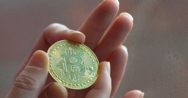 In this photo illustration a citizen holds a physical commemorative Bitcoin, , Dublin, Ireland, Jan. 5, 2020. (Getty Images)