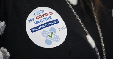 A sticker on a jacket after 10 people received their first dose of the Pfizer-BioNTech COVID-19 vaccine at Richard J. Daley College in Chicago, Jan 14, 2021. (AP Photo)