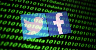 The Twitter and Facebook logos along with binary cyber codes in this illustration taken Nov. 26, 2019. (Reuters Photo)