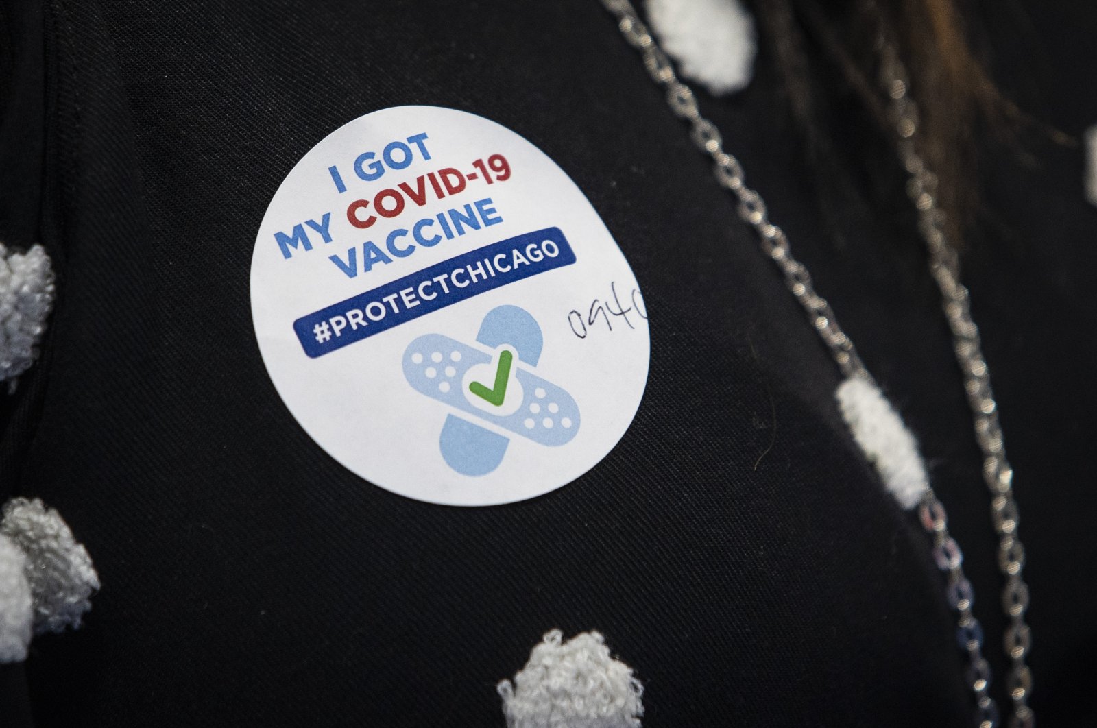 A sticker on a jacket after 10 people received their first dose of the Pfizer-BioNTech COVID-19 vaccine at Richard J. Daley College in Chicago, Jan 14, 2021. (AP Photo)
