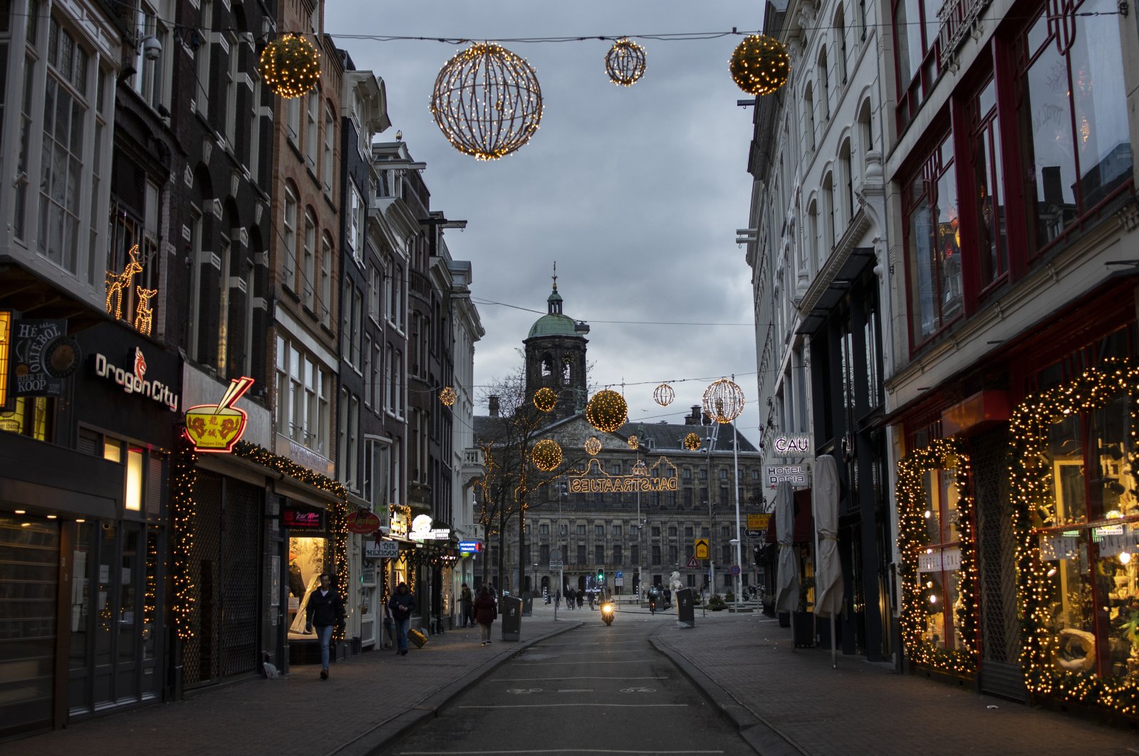 Closed stores on Dam street and the Royal Palace on Dam Square (C) in Amsterdam, Jan. 14, 2021. (AP Photo)