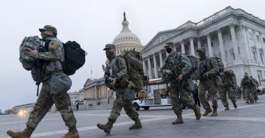 National Guard soldiers walk out of the U.S. Capitol as security is increased ahead of the inauguration of President-elect Joe Biden, Washington, Jan. 16, 2021. (AP Photo)