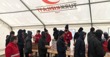 Turkish Red Crescent staff deliver food aid sent by the Turkish diaspora in Europe to migrants in Bihac, Bosnia-Herzegovina, Jan. 15, 2021. (AA PHOTO)