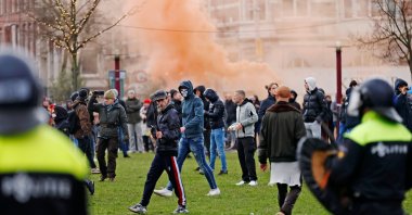 Riot police clash with protesters during a demonstration in the Museumplein town square in Amsterdam, Netherlands on Jan. 17, 2021. (AFP Photo)