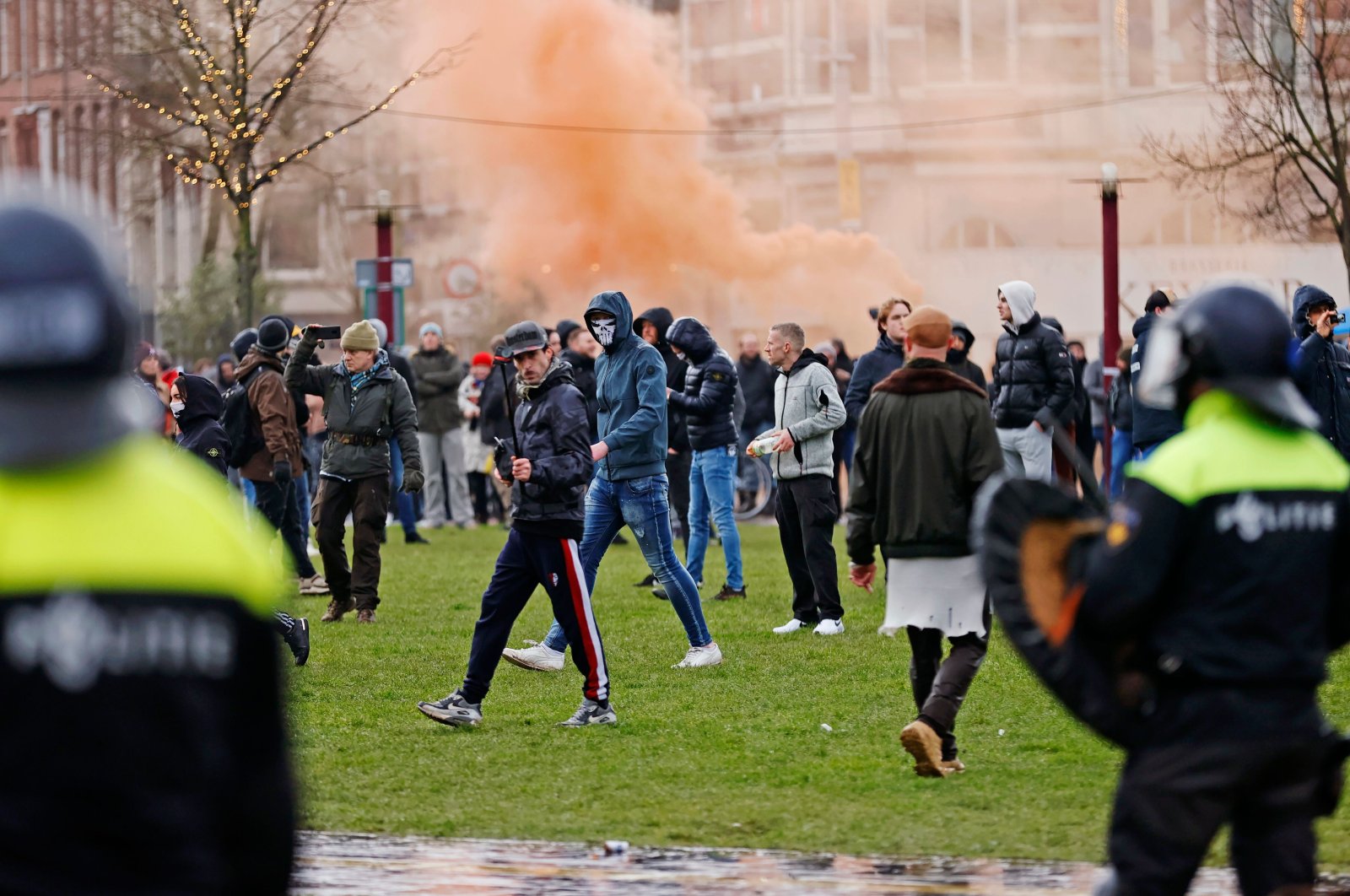 Riot police clash with protesters during a demonstration in the Museumplein town square in Amsterdam, Netherlands on Jan. 17, 2021. (AFP Photo)