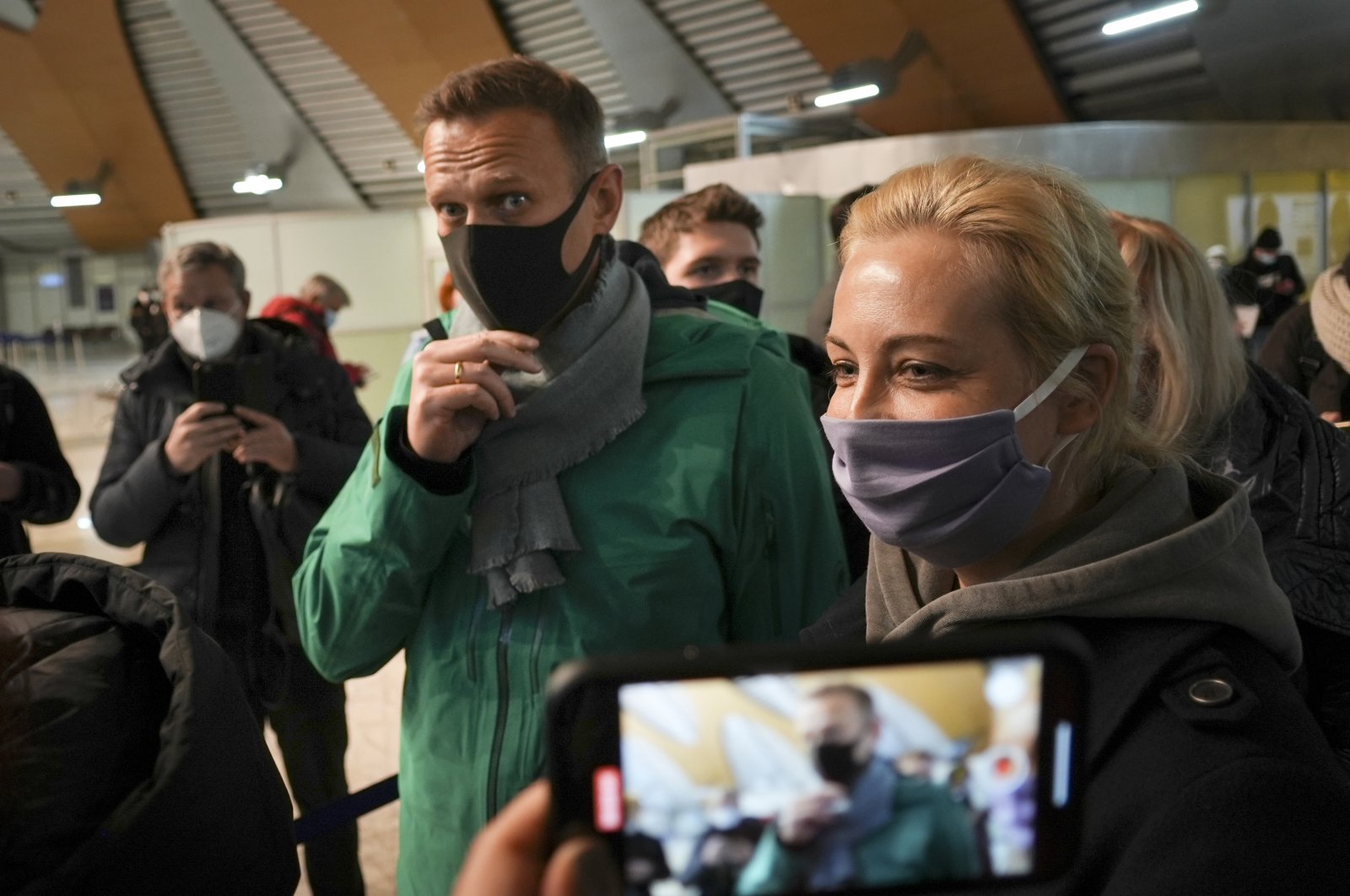 Alexei Navalny and his wife Yuliastand stand in line at the passport control after arriving at Sheremetyevo airport, outside Moscow, Russia, Jan. 17, 2021. (AP Photo)