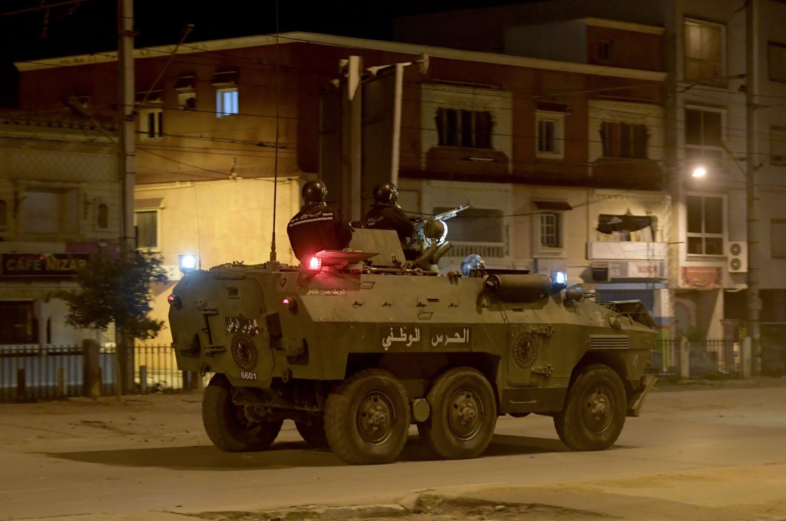 Members of the Tunisian National Guard sit atop their armored vehicle as they deploy on a street amid clashes with demonstrators following a protest in the Ettadhamen neighborhood in the capital Tunis, on Jan. 17, 2021. (AFP Photo)