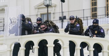Security officers point guns before pro-Trump supporters successfully breaching the U.S. Capitol building, Washington, D.C., U.S., Jan. 6, 2021. (AP Photo)