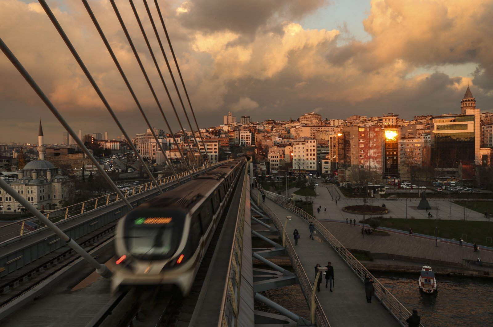 People walk at the Haliç metro station in Istanbul, Turkey, Jan. 14, 2021. (AP Photo)