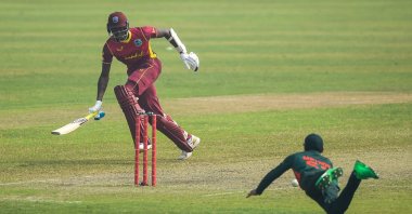 Bangladesh's Mehidy Hasan (R) attempts to run out West Indies' Alzarri Joseph during the second one-day international between Bangladesh and West Indies at the Sher-e-Bangla National Cricket Stadium, Dhaka, Jan. 22, 2021. (AFP Photo)