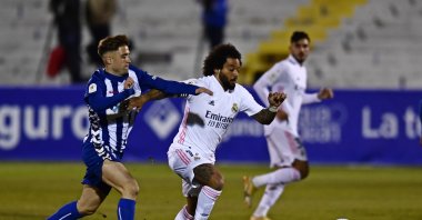 Real Madrid's Marcelo, center holds off Alcoyano's Alberto Rubio during a Spanish Copa del Rey round of 32 soccer match between Alcoyano and Real Madrid at the El Collao stadium in Alcoy, Spain, Jan. 20, 2021. (AP Photo)