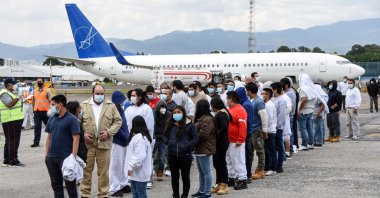 Guatemalan migrants deported from the United States, queue upon their arrival at the Air Force Base in Guatemala City on January 6, 2021. (AFP Photo)
