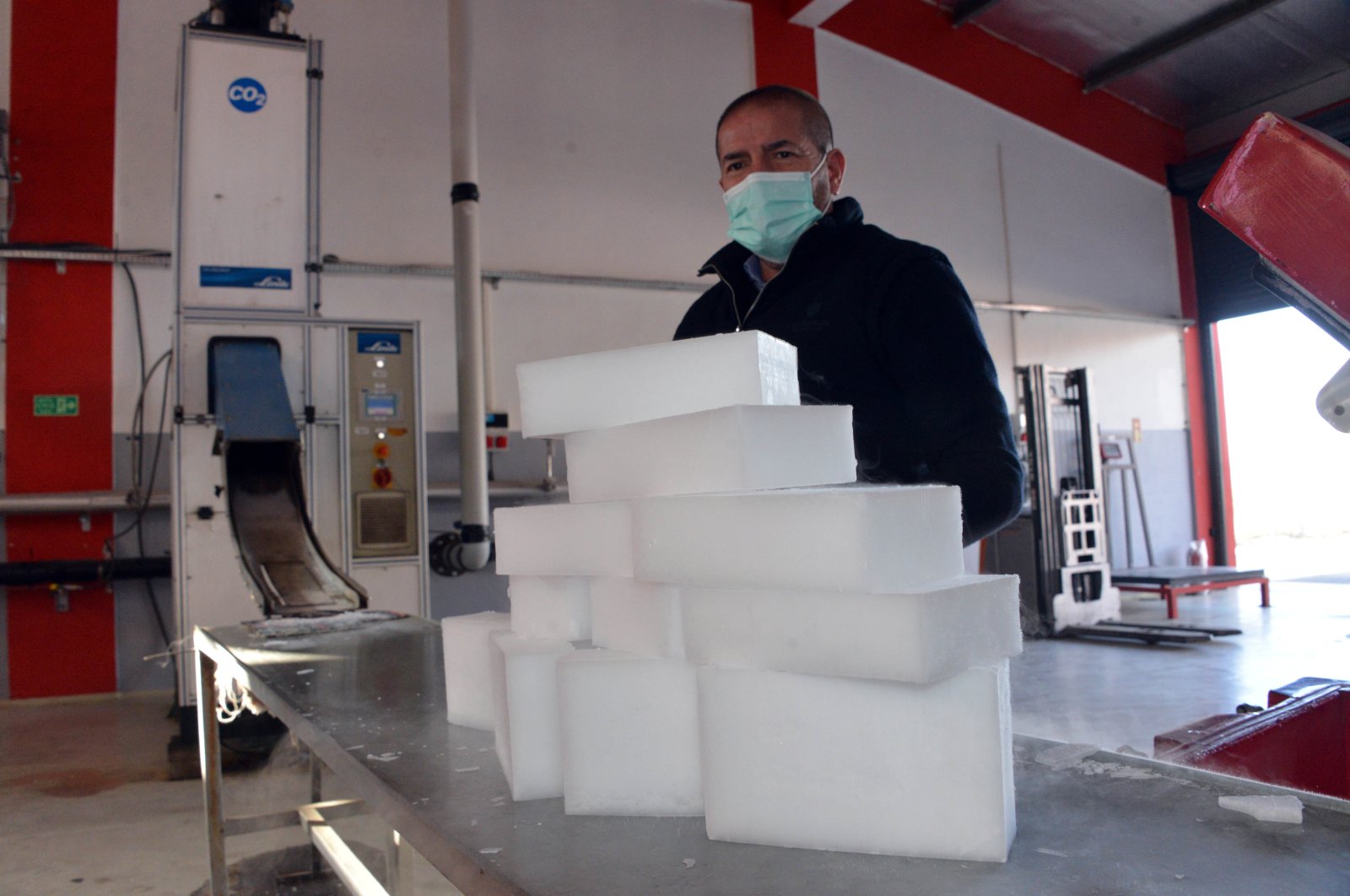 Sami Kervancıoğlu shows dry ice produced at the factory, in Kahramanmaraş, southern Turkey, Jan. 22, 2021. (DHA PHOTO) 