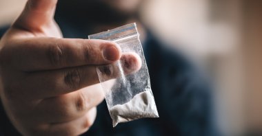 A man holds some cocaine in this file photo. (Shuttestock Photo)