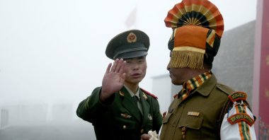 A Chinese soldier gestures as he stands near an Indian soldier on the Chinese side of the ancient Nathu La border crossing between India and China, July 10, 2008. (AFP Photo)