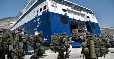 Greek soldiers prepare to board a ferry at the port of the tiny Greek island of Kastellorizo (Megisti-Meis), the southeasternmost inhabited Greek island in the Dodecanese, situated 2 kilometers (1.2 miles) off the south coast of Turkey, in Kastellorizo, Greece, Aug. 31, 2020. (AFP Photo)