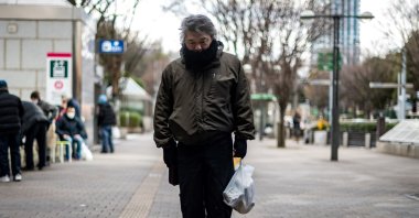 A man who identified himself as "Yuichiro" holds a bag of food distributed by nonprofit organization Moyai Support Centre for Independent Living, in the Shinjuku district of Tokyo, Japan, Jan. 9, 2021. (AFP Photo)