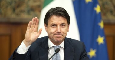 Italian Prime Minister Giuseppe Conte waves during a videoconference with members of the European Council on the EU response to the COVID-19 pandemic, Rome, Italy, Nov. 19, 2020. (AFP)