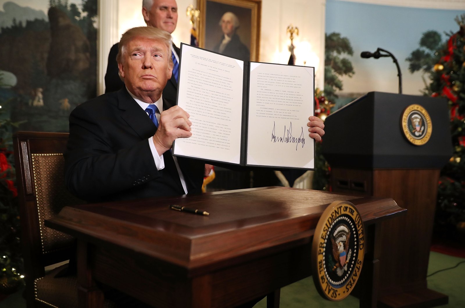 Then-U.S. President Donald Trump holds up a proclamation that recognizes Jerusalem as the capital of Israel, at the White House, Washington, D.C., Dec. 6, 2017. (Photo by Getty Images)