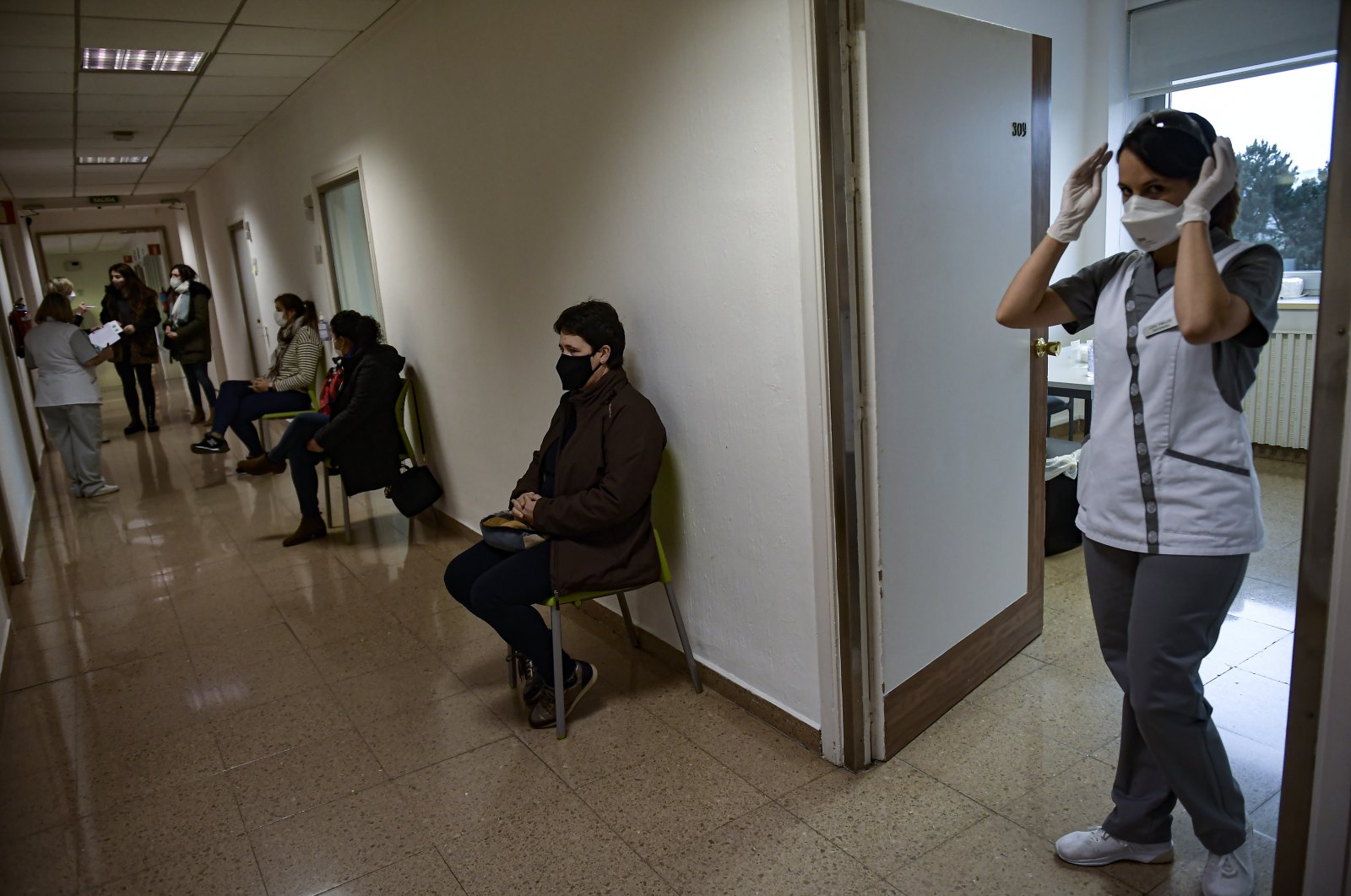 Staff health workers wait to be vaccinated with the Moderna coronavirus vaccine at Clinica Universitaria, in Pamplona, northern Spain, Jan. 20, 2021. (AP Photo)