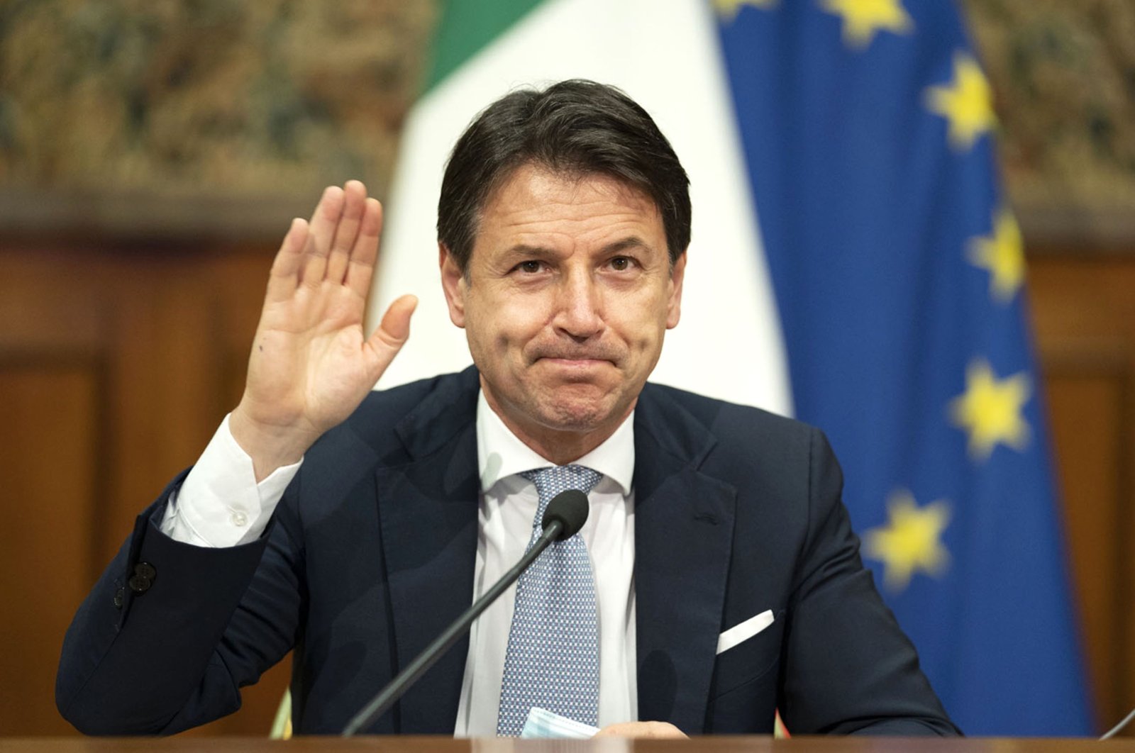 Italian Prime Minister Giuseppe Conte waves during a videoconference with members of the European Council on the EU response to the COVID-19 pandemic, Rome, Italy, Nov. 19, 2020. (AFP)