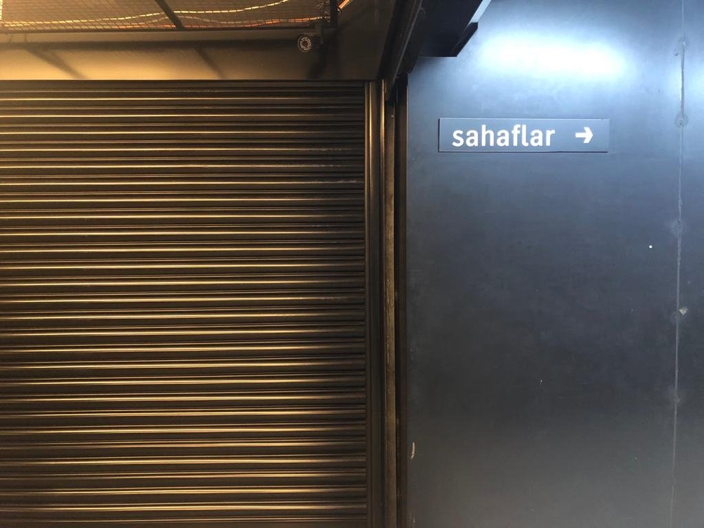 A sign points toward the sahafs inside Moda Sahne, which has essentially become a mini-mall of secondhand books, Kadıköy, Istanbul, Turkey. (Photo by Matt Hanson)
