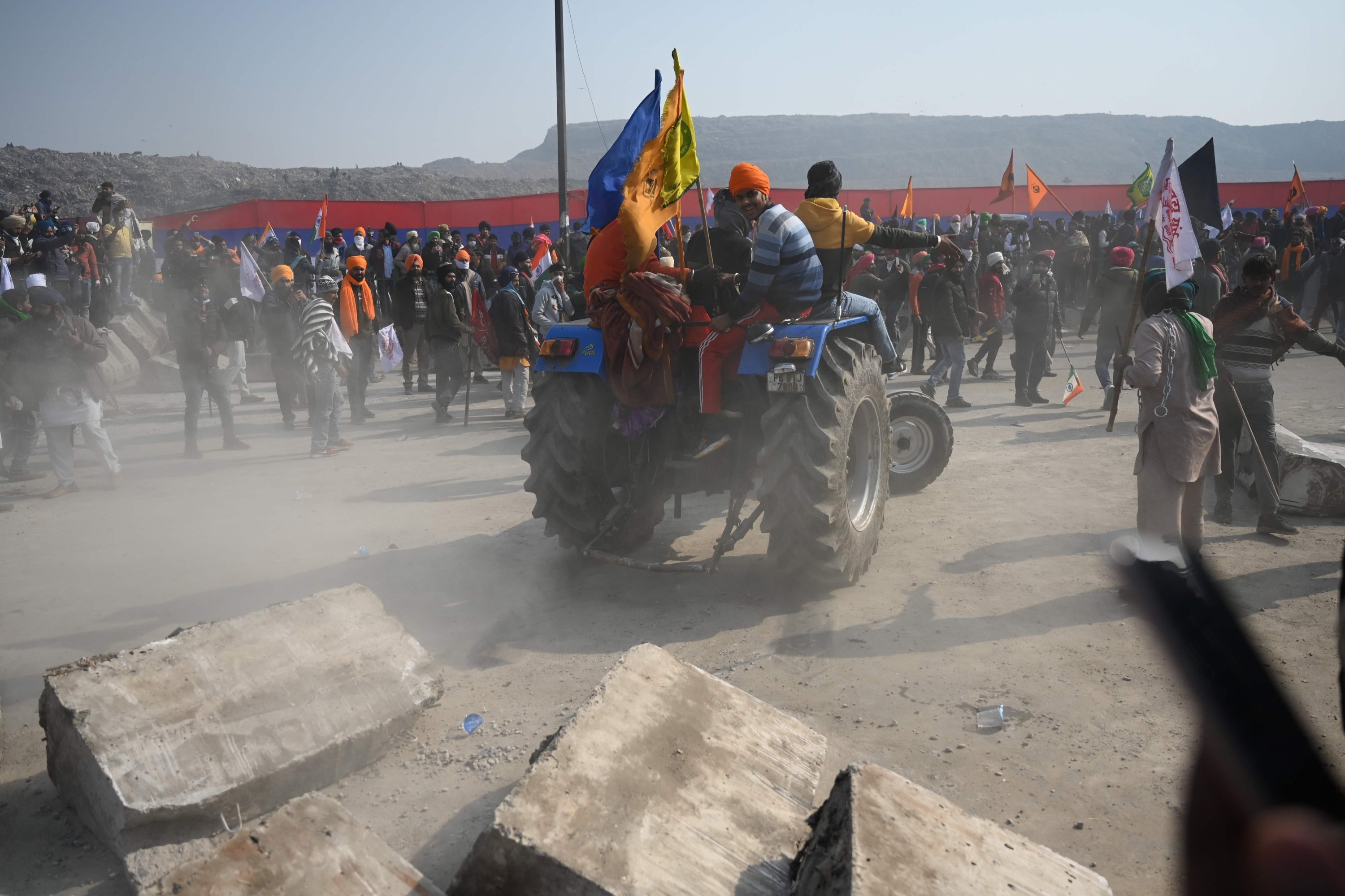 Farmers on a tractor prepare to remove concrete barricades installed by police during a rally against the central government's recent agricultural reforms in New Delhi, India, Jan. 26, 2021. (AFP Photo)