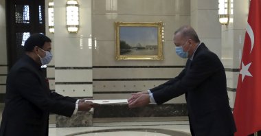 Turkey's President Recep Tayyip Erdoğan, wearing a face mask to protect against the spread of coronavirus, receives a letter of credentials from the new ambassador of India, Sanjay Kumar Panda, during a ceremony at the presidential palace, in Ankara, Turkey, Wednesday, Aug. 19, 2020. (Turkish Presidency via AP, Pool)