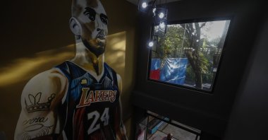 A fan enters a basketball facility dubbed the "House of Kobe" before the start of a ceremony marking the first death anniversary of the late basketball player Kobe Bryant in Valenzuela City, Metro Manila, Philippines, Jan. 26, 2021. (EPA Photo)