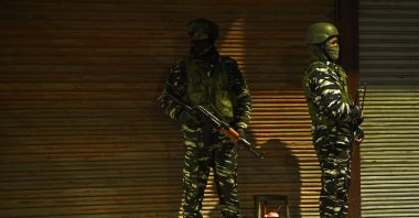 Paramilitary troopers stand guard along a street on the eve of India's Republic Day celebrations in Srinagar on January 25, 2021. (AFP Photo)